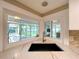 Corner kitchen sink with view of the backyard gazebo and screened patio at 9951 121St St, Seminole, FL 33772