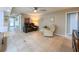 Living room with tile floors, a reclining sofa set, and neutral paint, creating a comfortable and inviting atmosphere at 9951 121St St, Seminole, FL 33772
