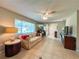 Cozy living room with tile flooring, comfortable sofa, and ceiling fan, providing a relaxing space at 9951 121St St, Seminole, FL 33772