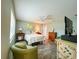 Spacious bedroom featuring hardwood flooring, a ceiling fan, a TV, and a relaxing seating area near the window at 9951 121St St, Seminole, FL 33772