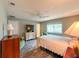 Bedroom with hardwood flooring, a ceiling fan, a window, and a TV, offering a relaxing retreat at 9951 121St St, Seminole, FL 33772
