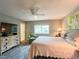 Bedroom with hardwood flooring, a ceiling fan, a TV, a window, and comfortable furnishings for relaxation at 9951 121St St, Seminole, FL 33772
