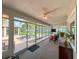 Sunroom with large windows overlooking the backyard gazebo and trees at 9951 121St St, Seminole, FL 33772