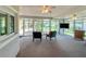 Bright and airy sunroom filled with natural light, featuring floor-to-ceiling windows at 9951 121St St, Seminole, FL 33772