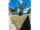 Spacious backyard with screened-in patio, white fence, and ample room for outdoor activities at 10444 Fordham St, Spring Hill, FL 34608