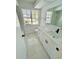 Updated bathroom with white cabinets, new fixtures, marble floors, and great natural light at 10444 Fordham St, Spring Hill, FL 34608