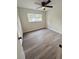 Bright bedroom features modern vinyl floors, ceiling fan, and window at 10444 Fordham St, Spring Hill, FL 34608