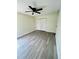 Bedroom featuring modern vinyl floors, fan, and large closet at 10444 Fordham St, Spring Hill, FL 34608