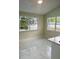 Dining room featuring polished marble flooring and view to the pool through large windows at 10444 Fordham St, Spring Hill, FL 34608