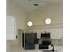 Modern kitchen with white cabinets, stainless steel appliances, and elegant lighting at 10444 Fordham St, Spring Hill, FL 34608