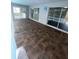 Covered lanai with tile flooring and access to the screened in pool at 10444 Fordham St, Spring Hill, FL 34608