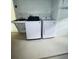 Laundry room with a utility sink, newer washer and dryer and shelving at 10444 Fordham St, Spring Hill, FL 34608