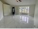 Spacious living area featuring polished marble flooring, a bay window, and natural light at 10444 Fordham St, Spring Hill, FL 34608