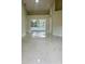 Bright living room with elegant marble floors and sliding glass doors overlooking the pool at 10444 Fordham St, Spring Hill, FL 34608