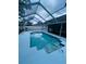 Sparkling pool with screened enclosure and tiled steps offers a refreshing outdoor retreat at 10444 Fordham St, Spring Hill, FL 34608