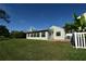 Expansive backyard featuring a screened-in porch and well-maintained lawn at 10921 Brightside Dr, Tampa, FL 33624