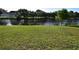 A grassy backyard with a view of a tranquil body of water at 10921 Brightside Dr, Tampa, FL 33624