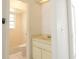 Compact bathroom with white tiled shower and beige vanity at 10921 Brightside Dr, Tampa, FL 33624