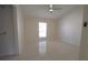 Empty bedroom features vaulted ceiling, tiled floors, and a window for natural light at 10921 Brightside Dr, Tampa, FL 33624
