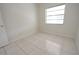Empty bedroom with a window and tile floors at 10921 Brightside Dr, Tampa, FL 33624