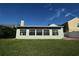Rear exterior with large windows and well-maintained lawn at 10921 Brightside Dr, Tampa, FL 33624