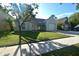 Charming single-story home with a well-manicured lawn, shade trees, and an attached garage at 10921 Brightside Dr, Tampa, FL 33624