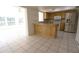 View of kitchen with tile flooring, stainless steel appliances, and wood cabinets at 10921 Brightside Dr, Tampa, FL 33624