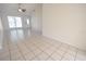 Bright living room with tile flooring, vaulted ceilings, and a front door view at 10921 Brightside Dr, Tampa, FL 33624