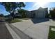 Wide street view of a single-Gathering home and lush green lawn on a sunny day at 10921 Brightside Dr, Tampa, FL 33624