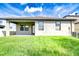 Backyard featuring a covered patio, green lawn, and a view of the home's rear exterior at 11011 Little Blue Heron Dr, Riverview, FL 33579