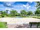 Outdoor basketball court with mature trees, benches, and attractive landscaping at 11011 Little Blue Heron Dr, Riverview, FL 33579