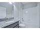 Bathroom featuring a tub-shower combo and modern vanity with granite countertop at 11011 Little Blue Heron Dr, Riverview, FL 33579