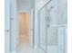 Clean bathroom with a glass-enclosed shower and an open doorway at 11011 Little Blue Heron Dr, Riverview, FL 33579