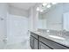 Bathroom featuring a tub-shower combo and double vanity with granite countertop at 11011 Little Blue Heron Dr, Riverview, FL 33579