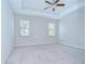Neutral Primary bedroom with tray ceilings, carpet, and bright natural light at 11011 Little Blue Heron Dr, Riverview, FL 33579