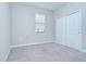 Carpeted bedroom has a closet and window with blind at 11011 Little Blue Heron Dr, Riverview, FL 33579