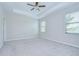 Airy Primary bedroom with tray ceilings, carpet, and bright natural light at 11011 Little Blue Heron Dr, Riverview, FL 33579
