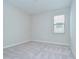 This carpeted bedroom has neutral walls and a single window at 11011 Little Blue Heron Dr, Riverview, FL 33579