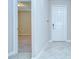 Entryway leading into carpeted room, and an exterior door and tiled floor entryway at 11011 Little Blue Heron Dr, Riverview, FL 33579