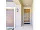 Charming front entrance with a brown door, brick-paved walkway, and well-lit surroundings at 11011 Little Blue Heron Dr, Riverview, FL 33579