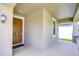 Inviting front porch with a stylish front door, brick flooring, and classic outdoor lighting at 11011 Little Blue Heron Dr, Riverview, FL 33579