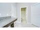 Hallway features granite countertop nook that leads to a bright bathroom at 11011 Little Blue Heron Dr, Riverview, FL 33579