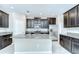 Modern kitchen features granite countertops, stainless steel appliances, and dark wood cabinetry at 11011 Little Blue Heron Dr, Riverview, FL 33579
