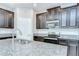 Close-up of the kitchen island with a granite countertop and sink at 11011 Little Blue Heron Dr, Riverview, FL 33579