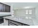 Spacious kitchen island with a granite countertop and stainless steel sink, perfect for entertaining at 11011 Little Blue Heron Dr, Riverview, FL 33579