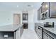 Bright kitchen showcasing an island with sink, granite countertops, and stainless steel appliances at 11011 Little Blue Heron Dr, Riverview, FL 33579