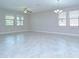 Bright living area with tile flooring, overhead fans, chandelier, and lots of natural light at 11011 Little Blue Heron Dr, Riverview, FL 33579