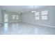 Spacious living room featuring tile floors, neutral paint, and large windows with natural light at 11011 Little Blue Heron Dr, Riverview, FL 33579
