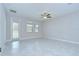 Bright living area with tile flooring, fan and door to lanai with lots of natural light at 11011 Little Blue Heron Dr, Riverview, FL 33579