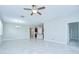 Open living space with tile floors, modern lighting and easy access to the kitchen at 11011 Little Blue Heron Dr, Riverview, FL 33579